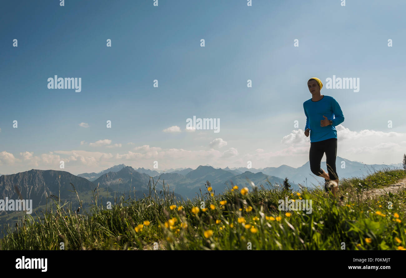 Austria, Tyrol, Tannheim Valley, young man jogging in mountains Stock Photo