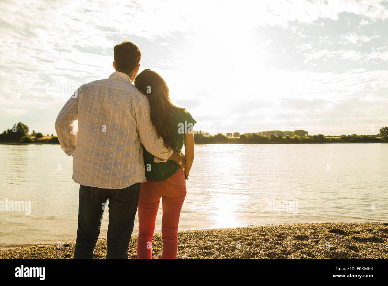 Relaxed man standing riverside looking view hi-res stock photography ...