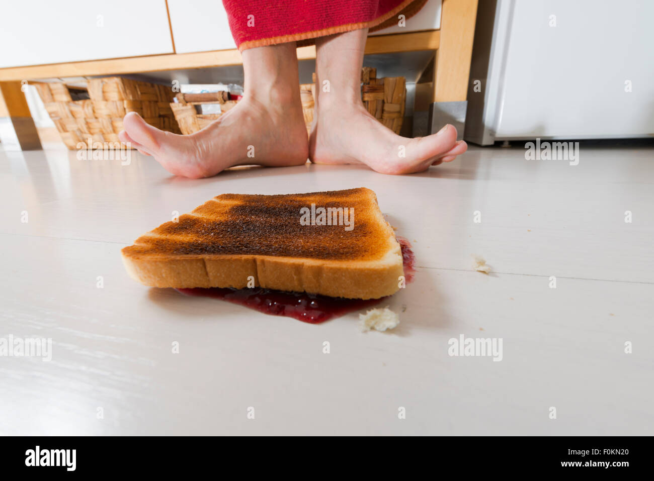 Toast with jam lying backwards on floor Stock Photo - Alamy