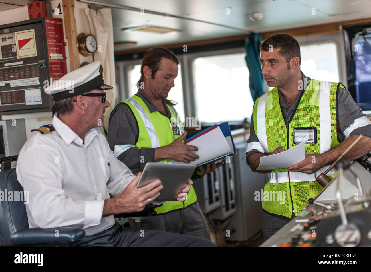 Ship crew and captain on bridge Stock Photo Alamy