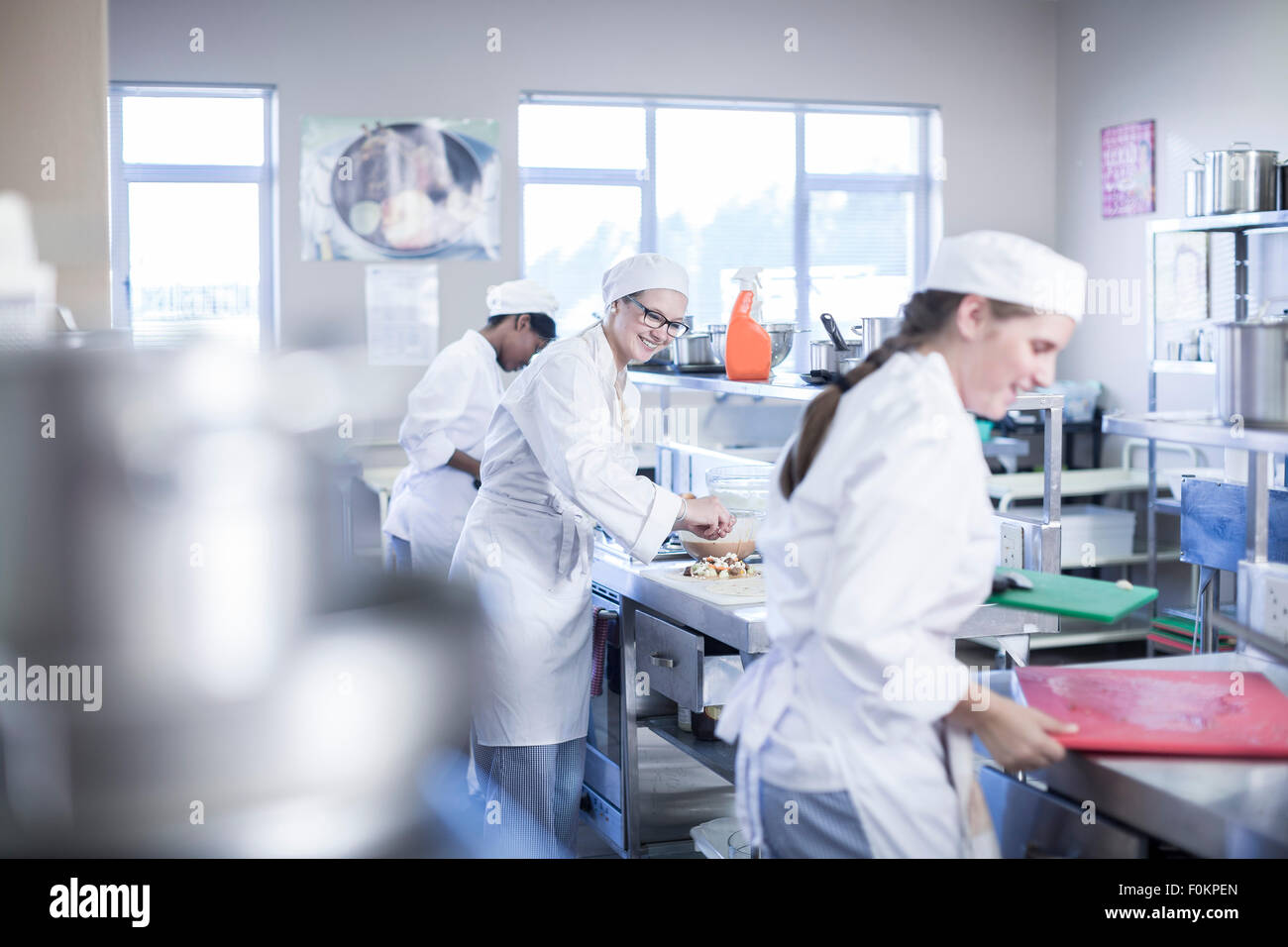 Teenagers cooking in canteen kitchen Stock Photo Alamy