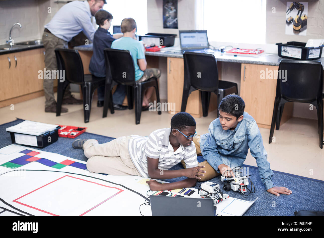 Schoolboys in robotics class testing vehicle on test track Stock Photo