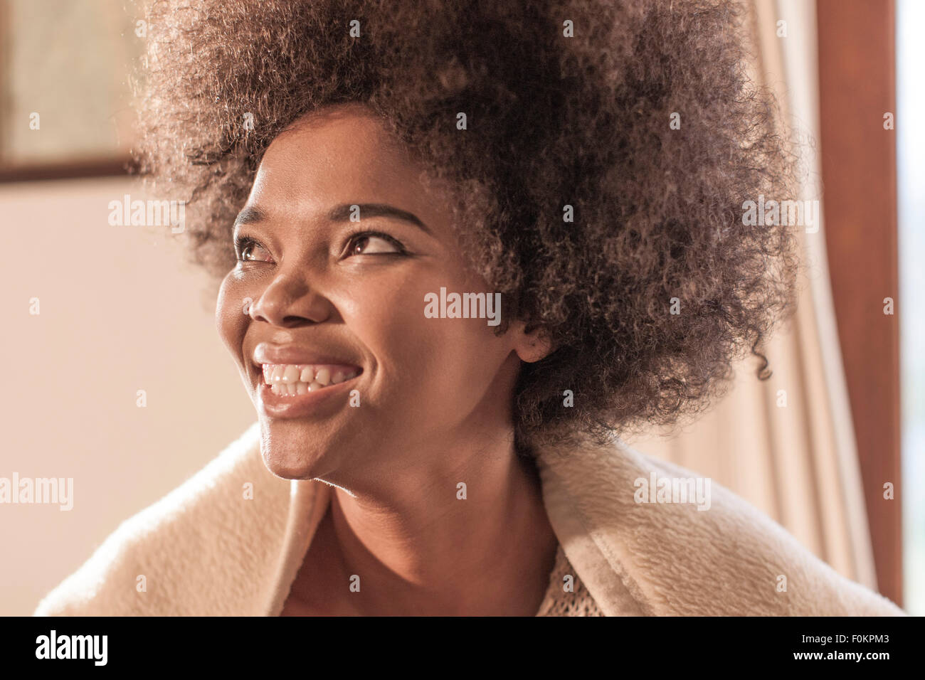 Happy young woman wrapped in a blanket Stock Photo - Alamy