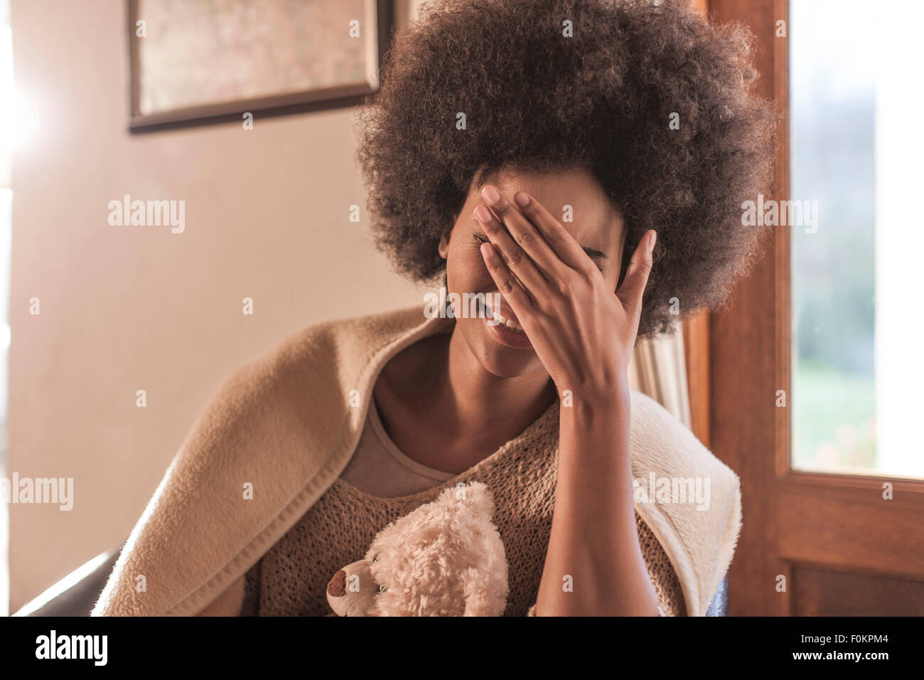 Happy young woman wrapped in a blanket Stock Photo - Alamy