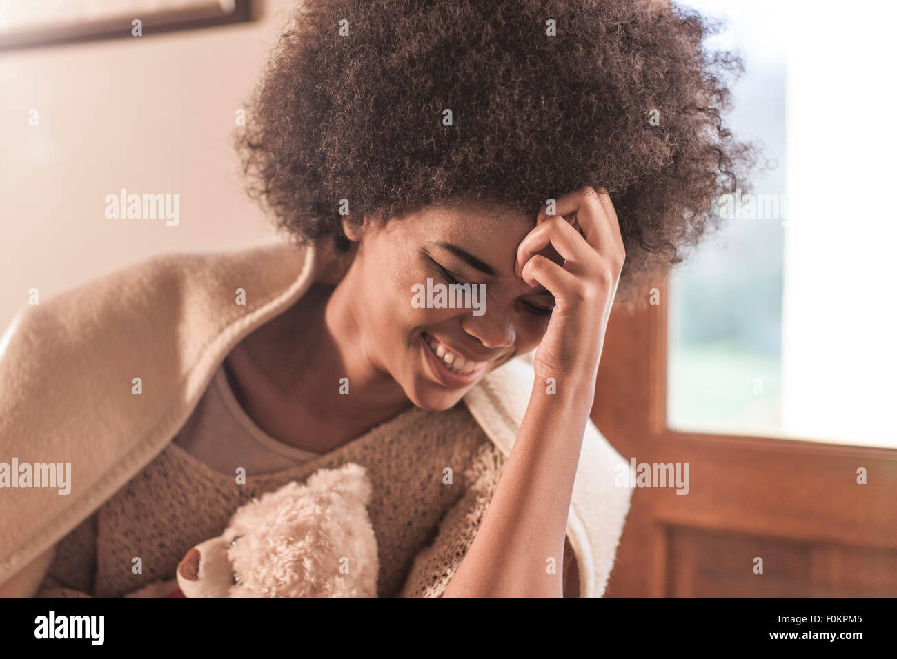 Happy young woman wrapped in a blanket Stock Photo - Alamy