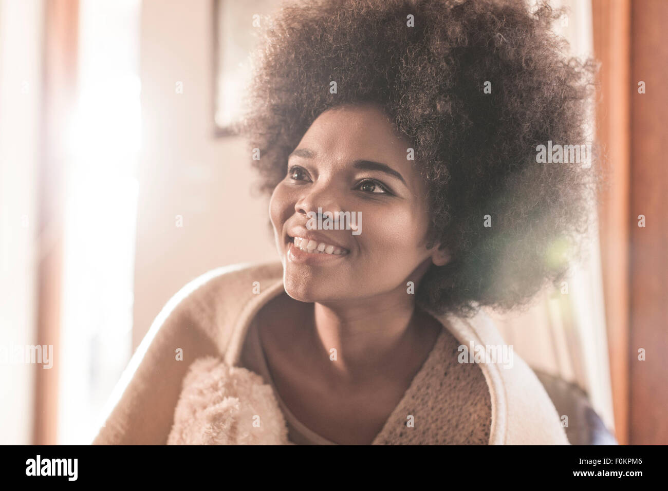 Happy young woman wrapped in a blanket Stock Photo - Alamy