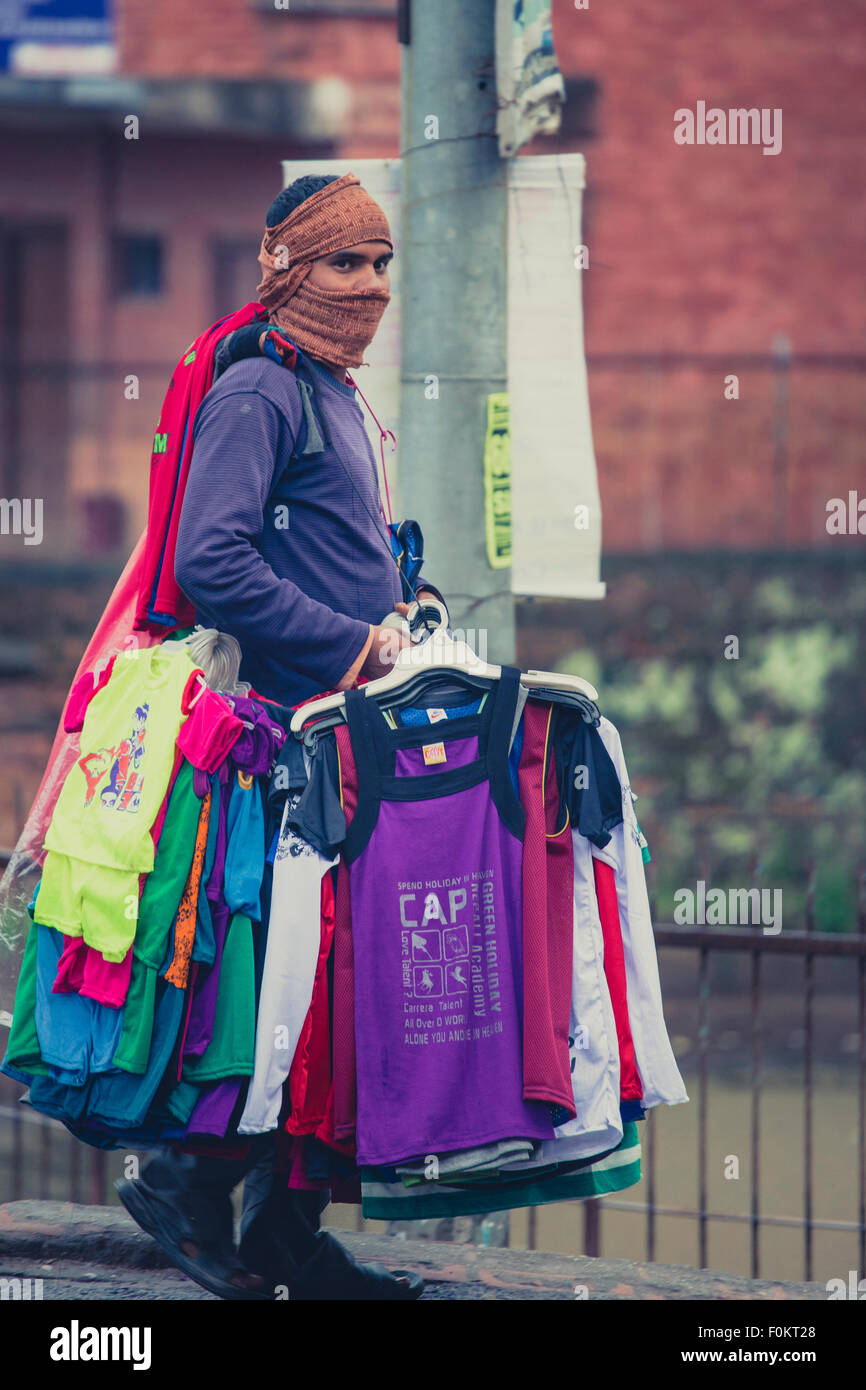 Unidentified Young man Selling colorful western clothes in the streets of Bhaktapur, Nepal, 23 April Stock Photo
