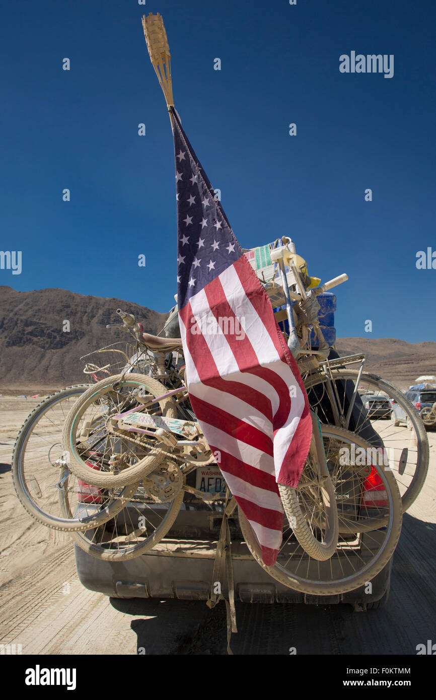 Mountain bikes on a car rack taken at the exit of the Burning Man festival in 2012 with US flags Stock Photo