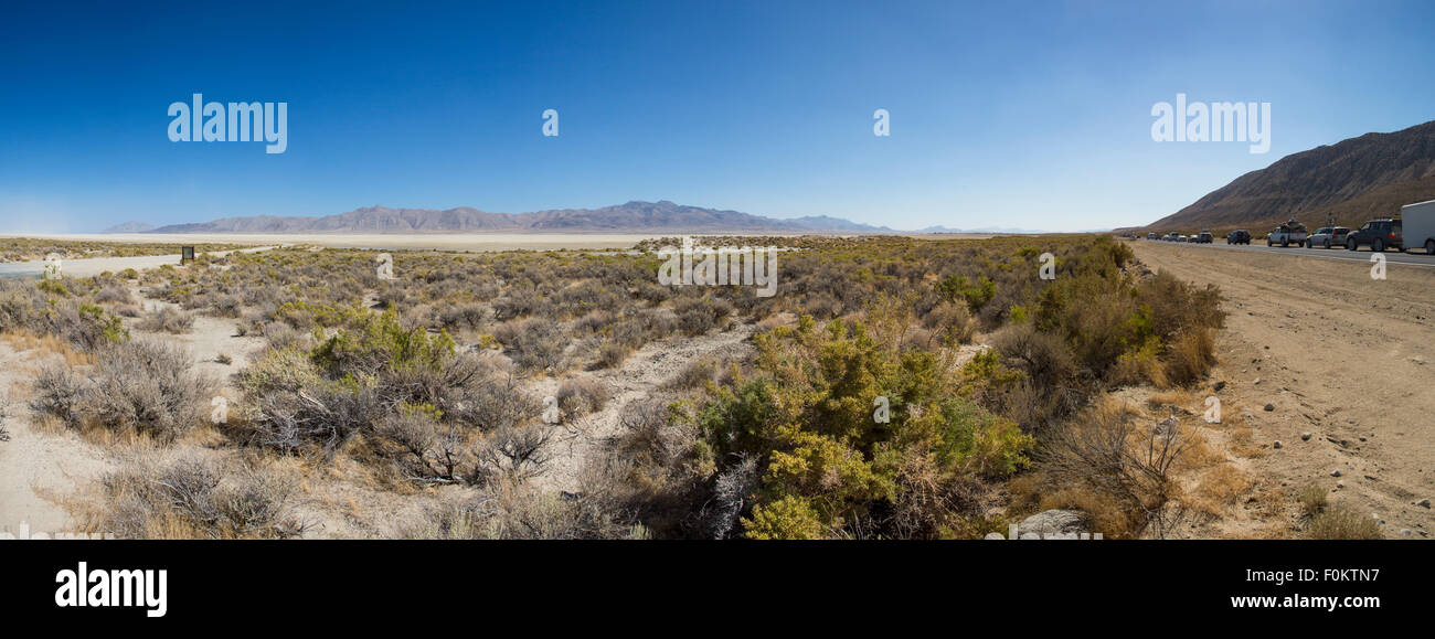 Panoramic view of the traffic on the road and the Black Rock Desert in Nevada. All the cars are leaving the site. Stock Photo