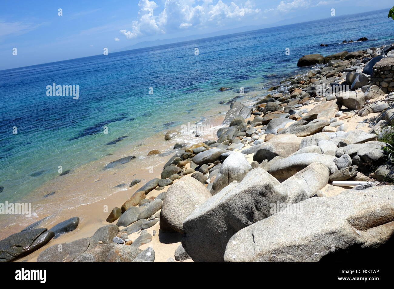 Stone beach with clear turquoise water near Puerto Vallarta, Mexico. Stock Photo