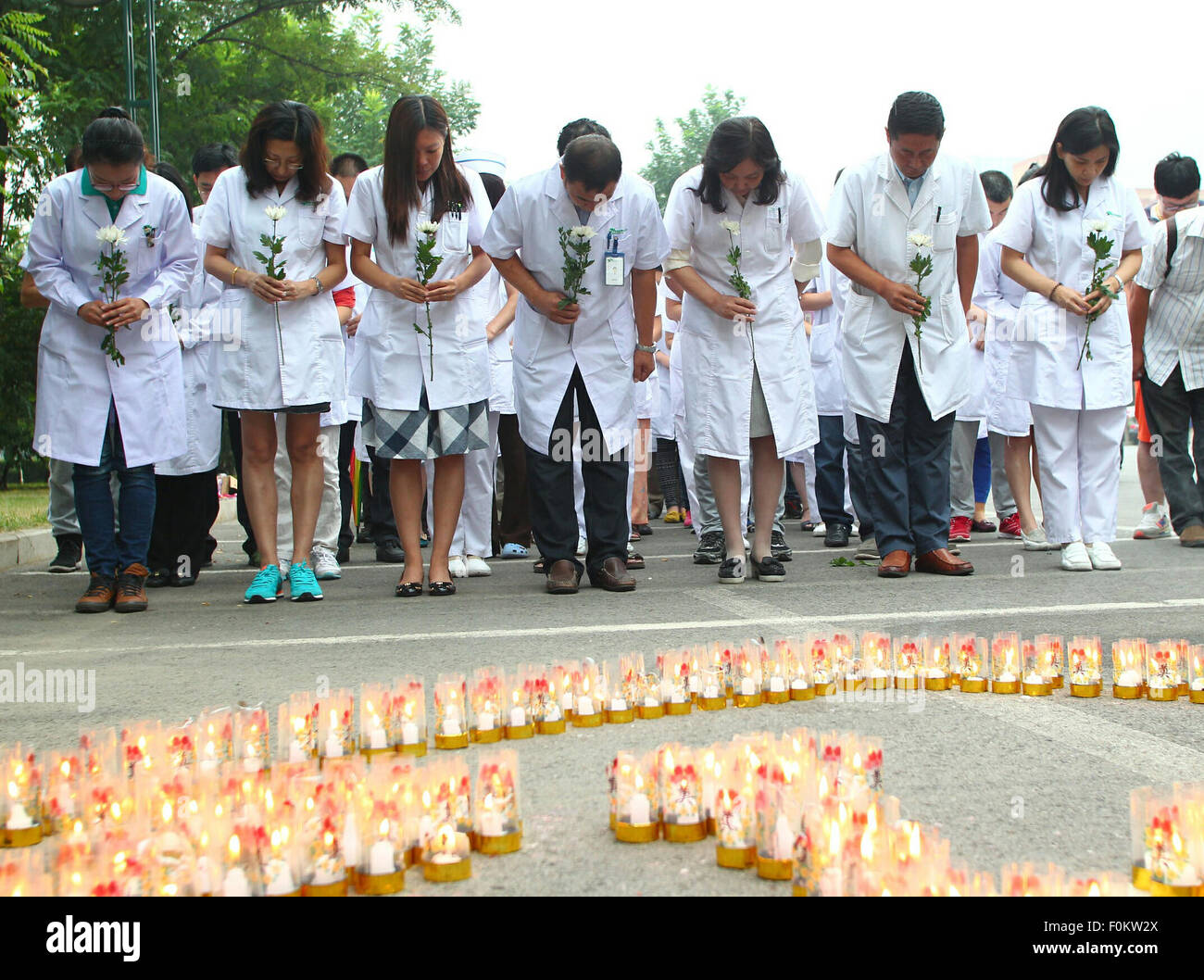 Tianjin, China. 18th Aug, 2015. A mourning ceremony is held for the victims of the massive warehouse explosions at Taida Hospital near the explosion site in Tianjin, north China, Aug. 18, 2015. The death toll from last week's massive blasts in Tianjin rose to 114. Credit:  Chen Yichen/Xinhua/Alamy Live News Stock Photo