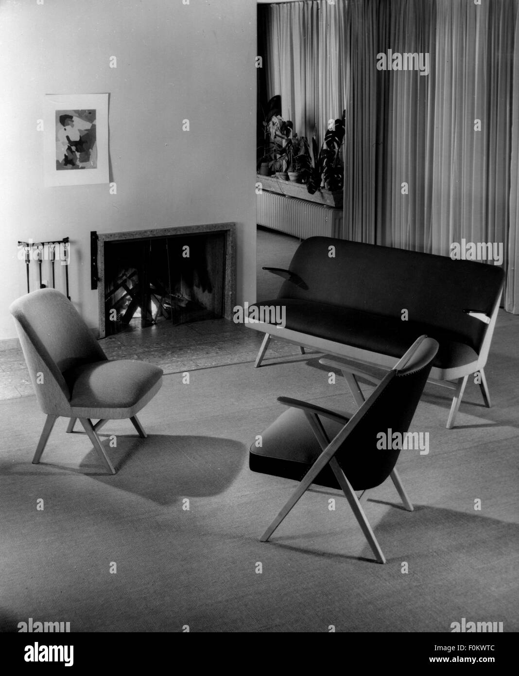 furnishings, seats with fireplace, 1950s chairs, chair, sofa, settee, sofas, settees, couch, chaise, chaise longue, couches, chaises, chaise longues, bench, benches, cool, coolness, chill, functional, open fireplace with fire, living-room, sitting-room, livingroom, living-rooms, sitting-rooms, livingrooms, lifestyle, living, live, dwelling, flat, seat, seats, seating furniture, furniture, furnishing, interior furnishings, salon, parlor, parlour, parlors, parlours, sitting room, sitting rooms, room, rooms, 1950s, 20th century, historic, historical, Additional-Rights-Clearences-Not Available Stock Photo