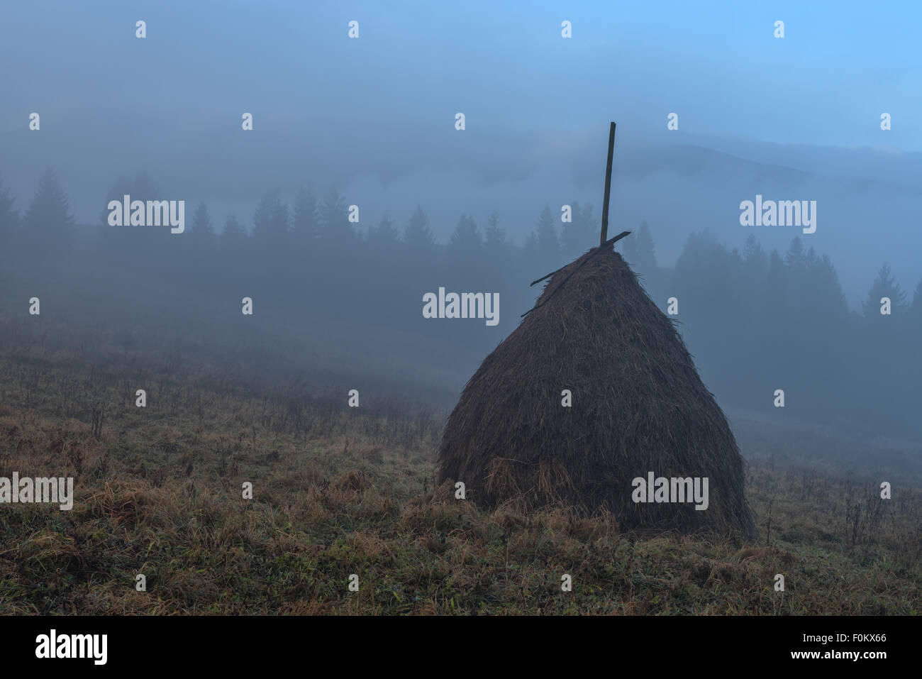 Amazing rural scene on autumn valley. Alone haystack on a foreground. Carpathians, Ukraine, Europe. Stock Photo