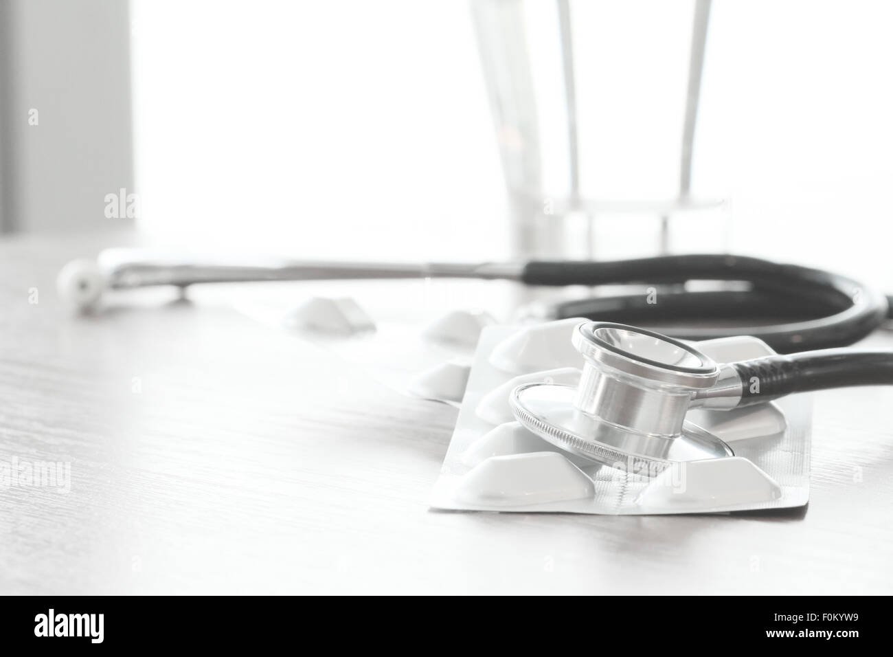 Studio macro of a stethoscope and digital tablet abstract on wood table ...