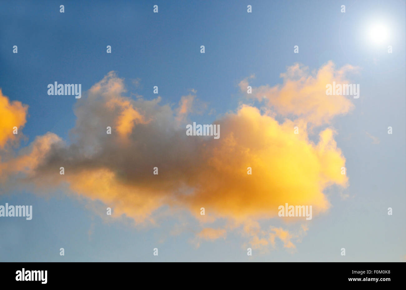 Afternoon clouds with the sun shining through Stock Photo - Alamy