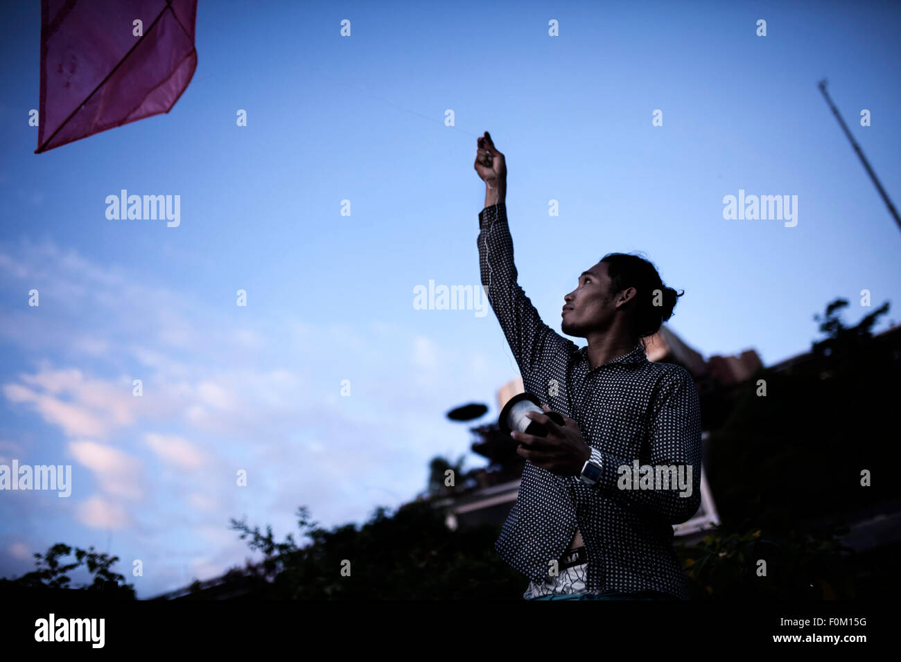 Young man flying a kite, Bali Stock Photo