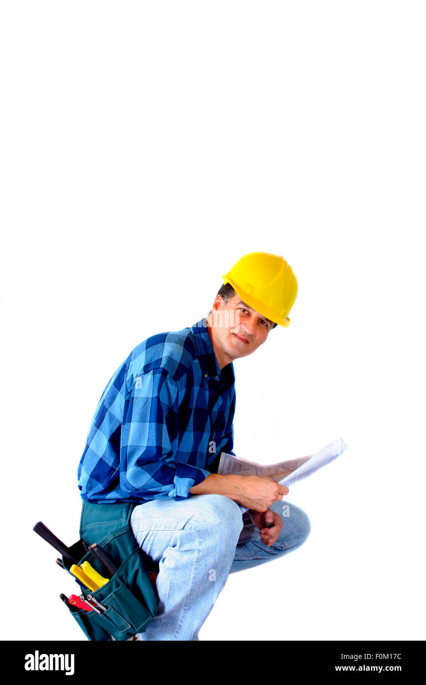 Contractor kneeling with a blueprint isolated on white Stock Photo