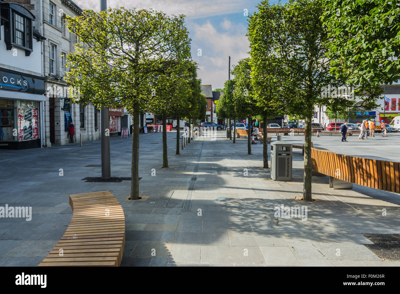 Newtownards, County Down, Northern Ireland, UK.   17th August, 2015.   Public Realm work nearing completion but still disrupting shopping and trade  Members of the public and Public Realm workers  The scheme, which is being match-funded and delivered by the Council, is intended to reinvigorate Newtownards, transforming the visual appearance of the town centre and enhancing its appeal as a place to visit and shop, generating a positive economic impact.  Work is due to be completed for Summer 2016.  Jeffrey Silvers/Alamy Live News Stock Photo