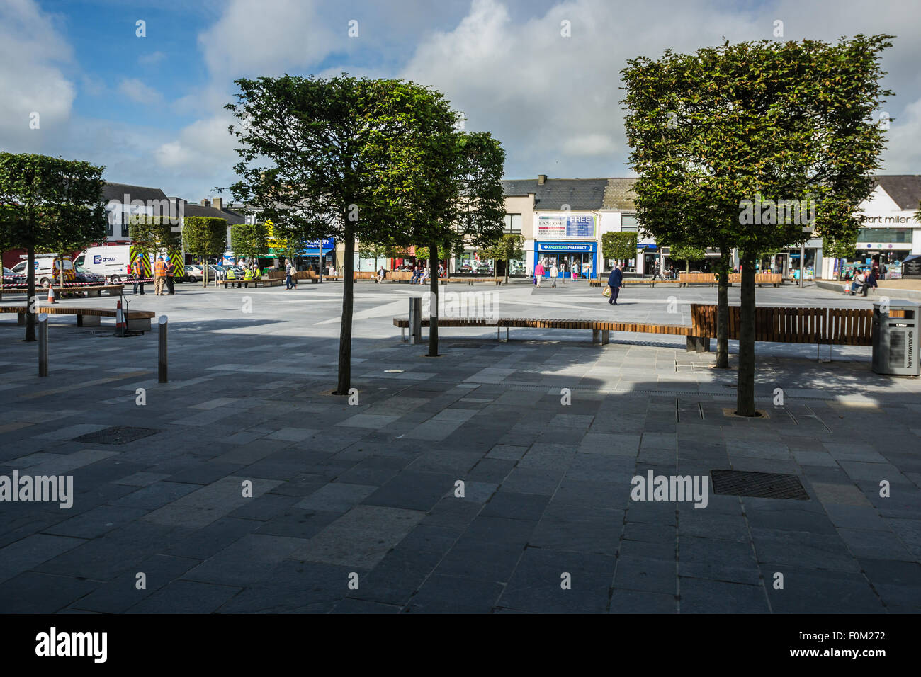 Newtownards, County Down, Northern Ireland, UK.   17th August, 2015.   Public Realm work nearing completion but still disrupting shopping and trade  Members of the public and Public Realm workers  The scheme, which is being match-funded and delivered by the Council, is intended to reinvigorate Newtownards, transforming the visual appearance of the town centre and enhancing its appeal as a place to visit and shop, generating a positive economic impact.  Work is due to be completed for Summer 2016.  Jeffrey Silvers/Alamy Live News Stock Photo