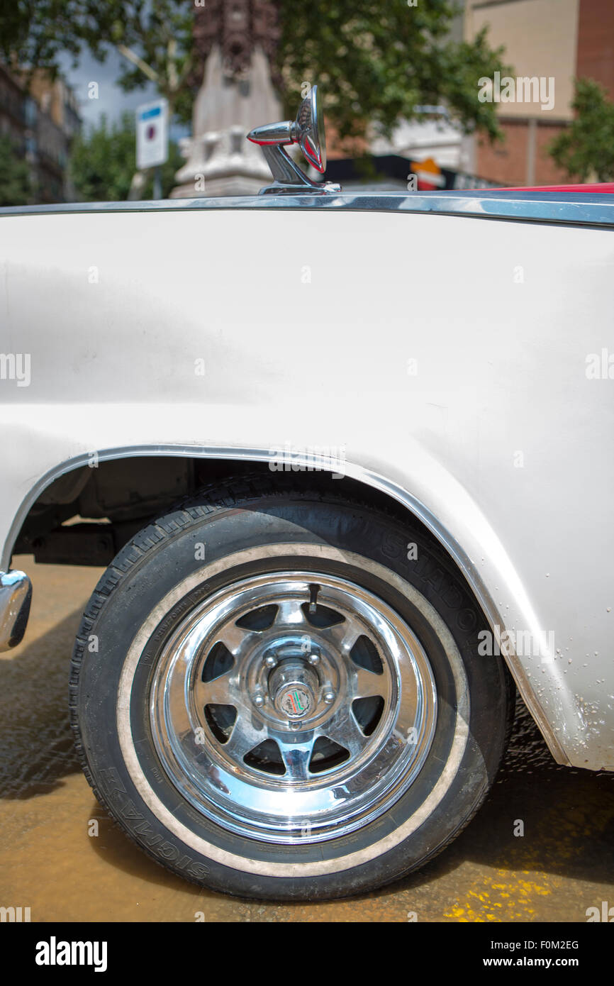Detail of a fancy wheel of an American vintage car taken in the street of Barcelona in Spain. Stock Photo