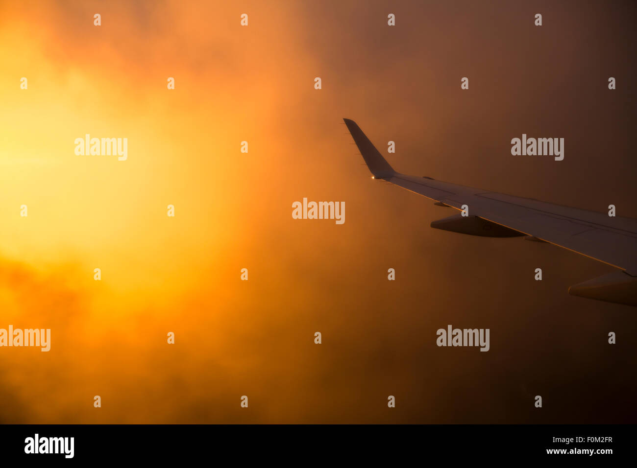 Airplane at sunrise Stock Photo