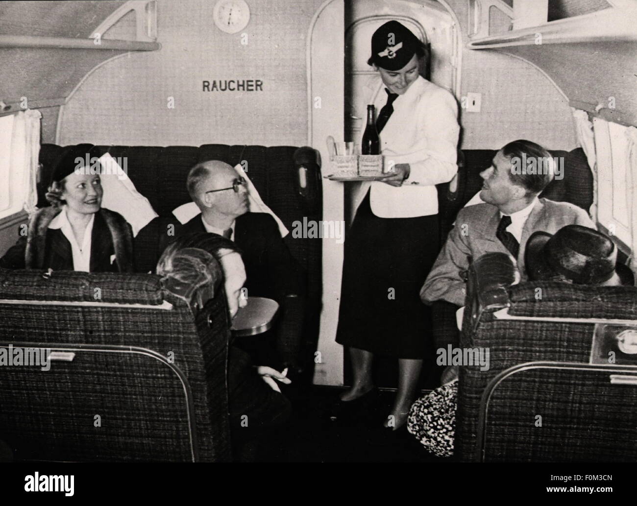 transport / transportation,aviation,passenger planes,interior,Focke-Wulf 200,German Lufthansa,circa 1930,1930s,30s,20th century,historic,historical,smoking compartment,smoker,smoking compartments,smokers,stewardess,air hostess,stewardesses,air hostesses,flight attendant,tray,trays,service,servicing,serving,comfort,board,foods,meals,catering,feeding,service,provision of food and drink,cabin,cabins,air passenger,air passengers,bumpee,flight,flights,travel by air,travels by air,travel by air,traveler,traveller,traveler,Additional-Rights-Clearences-Not Available Stock Photo