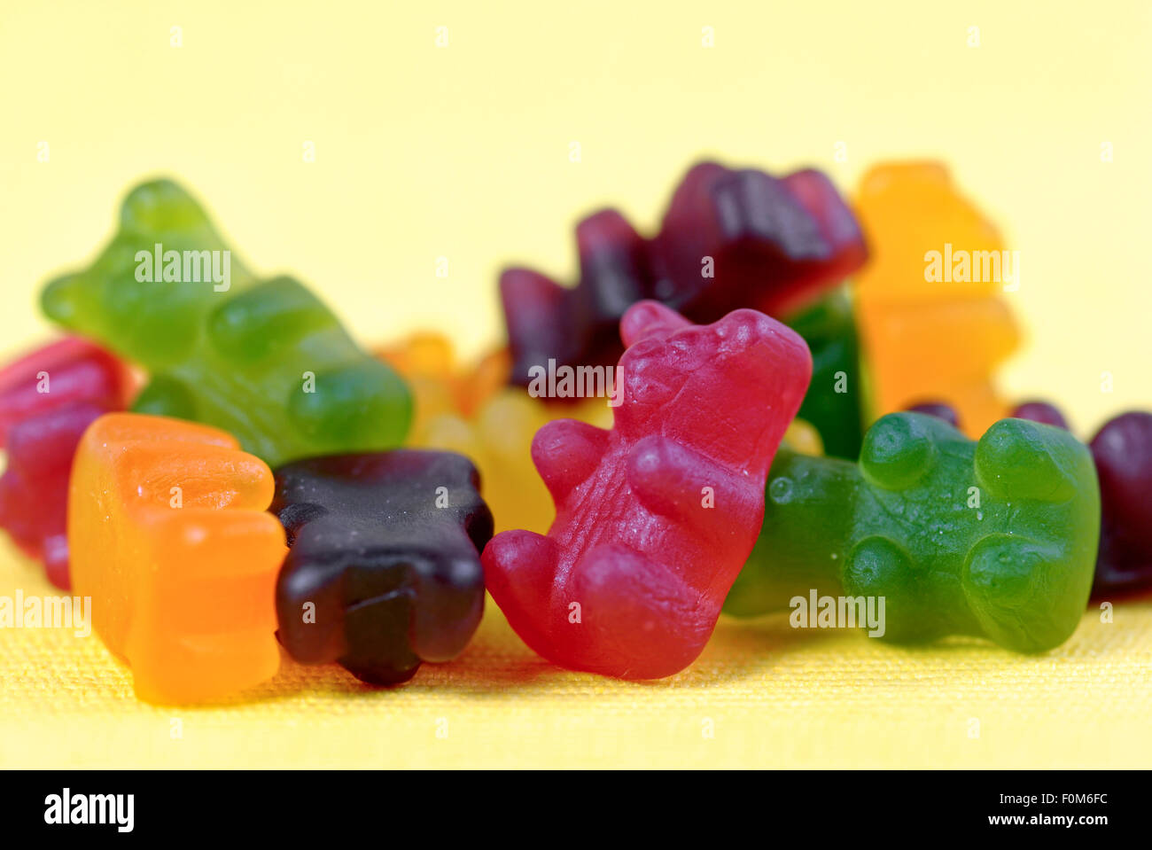 Jelly bears (also called gummy or gummi bears) on yellow background Stock Photo
