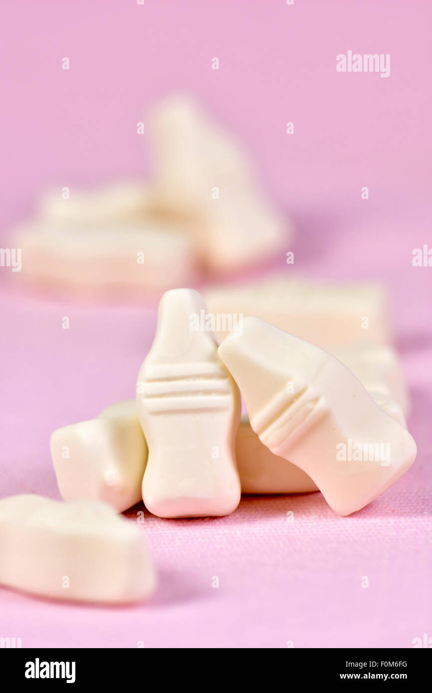Milk bottle sweets on pink background Stock Photo Alamy