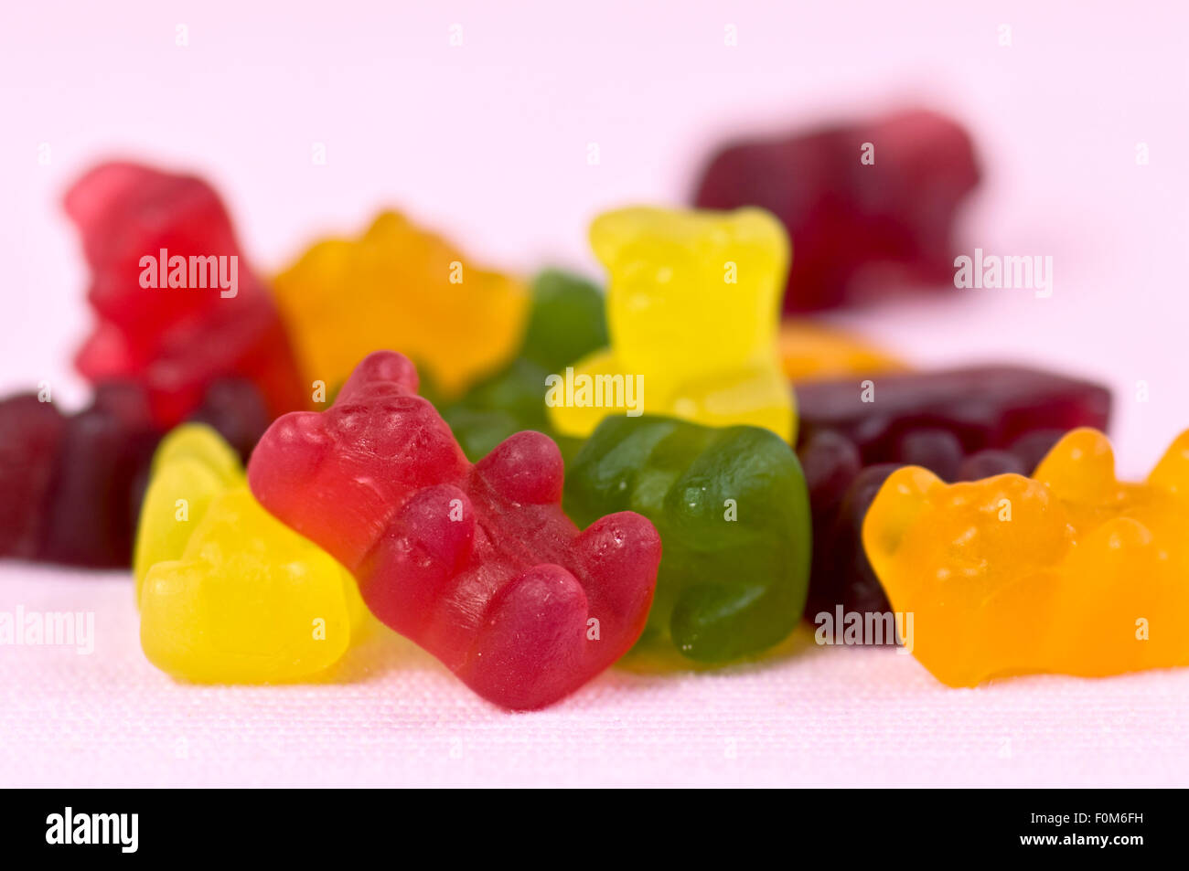 Jelly bears (also called gummy or gummi bears) on pink background Stock Photo