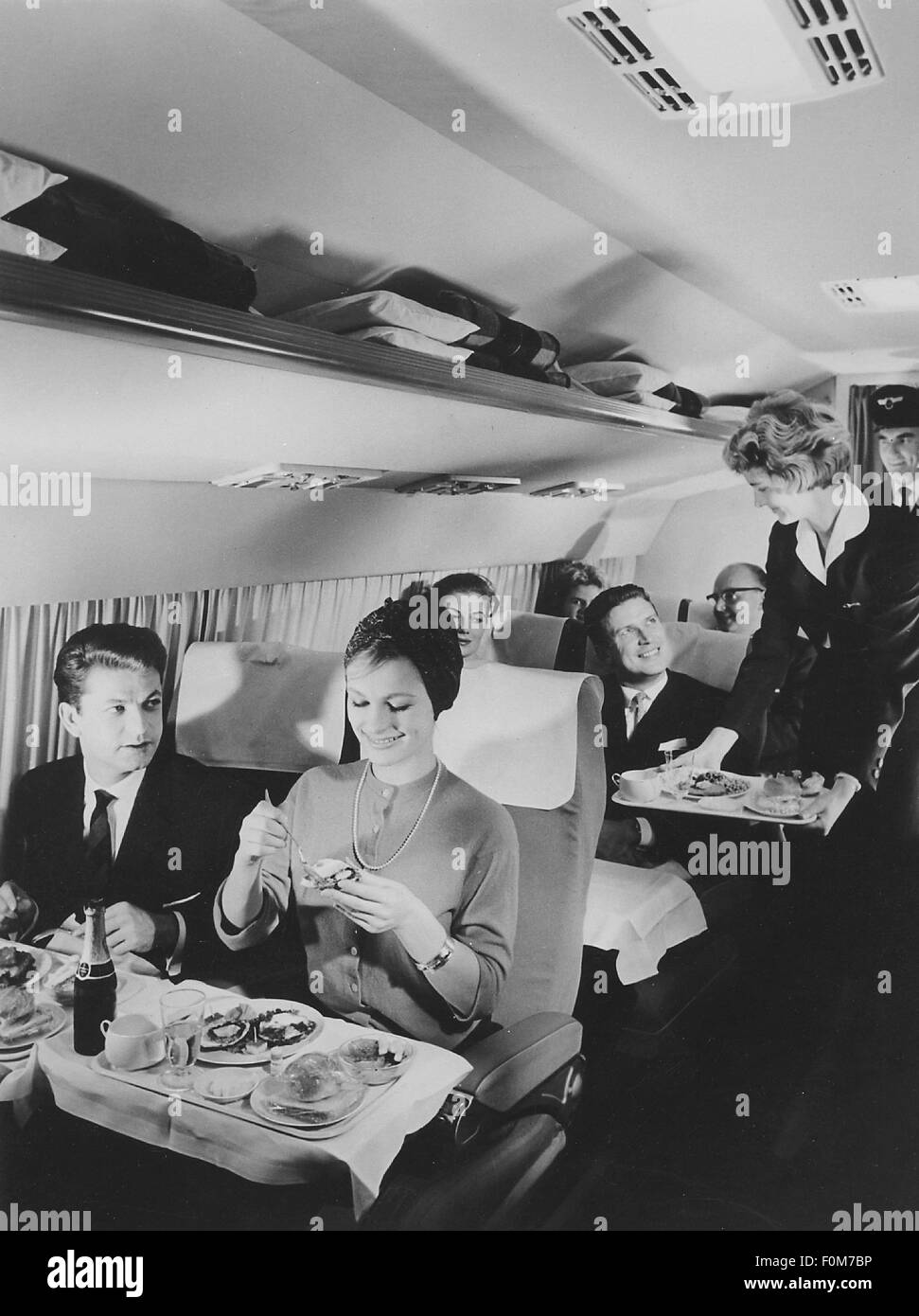 transport / transportation,aviation,passengers,eating passengers,1950s,50s,20th century,historic,historical,Lufthansa,German,stewardess,air hostess,stewardesses,air hostesses,flight attendant,tray,trays,service,servicing,serving,comfort,board,foods,meals,catering,feeding,service,provision of food and drink,cabin,cabins,air passenger,air passengers,bumpee,flight,flights,travel by air,travels by air,travel by air,traveler,traveller,travelers,travellers,travel,travels,flying,passenger planes,passenger plane,airliner,,Additional-Rights-Clearences-Not Available Stock Photo