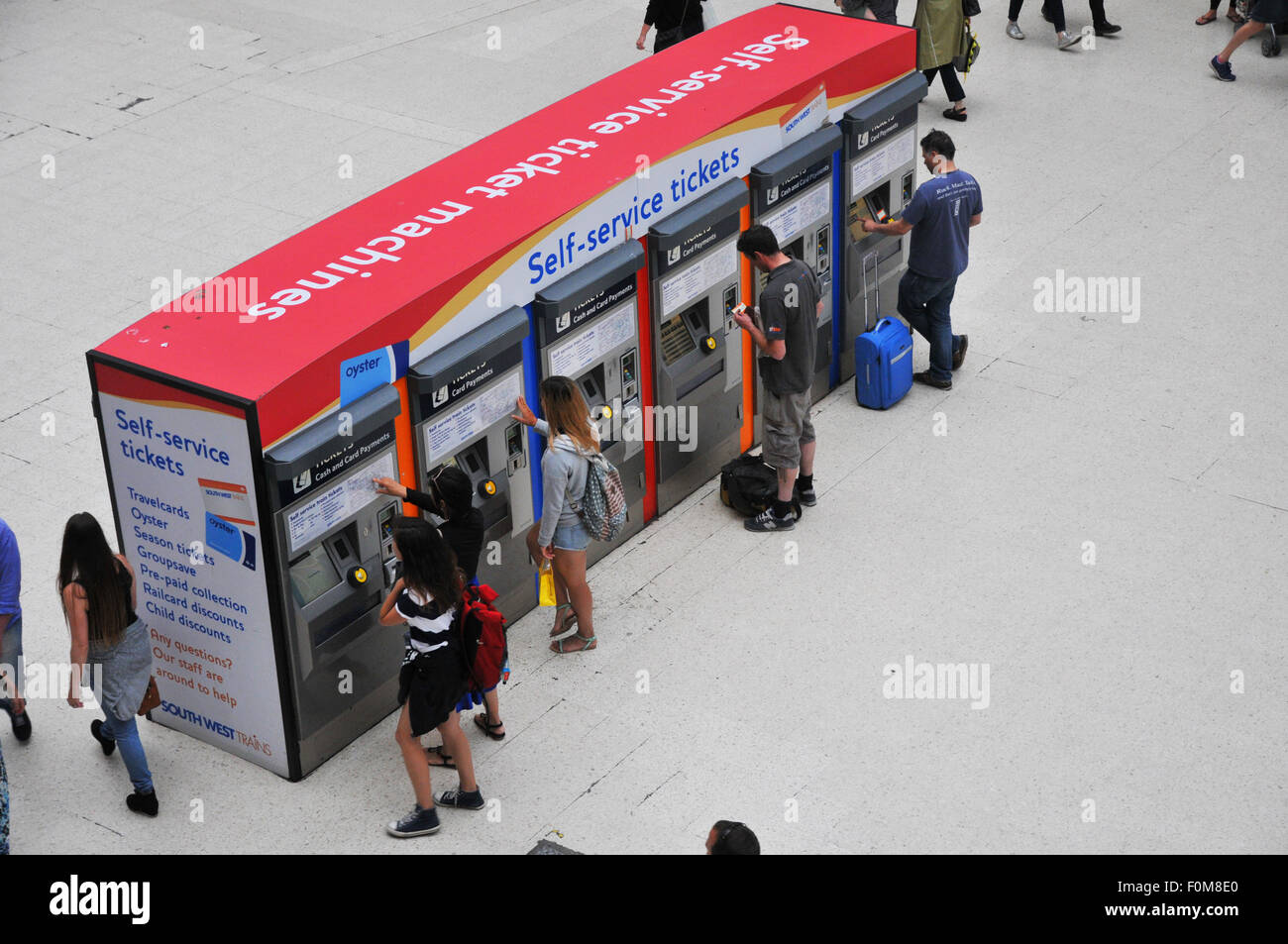 image from above of people buying train tickets Stock Photo