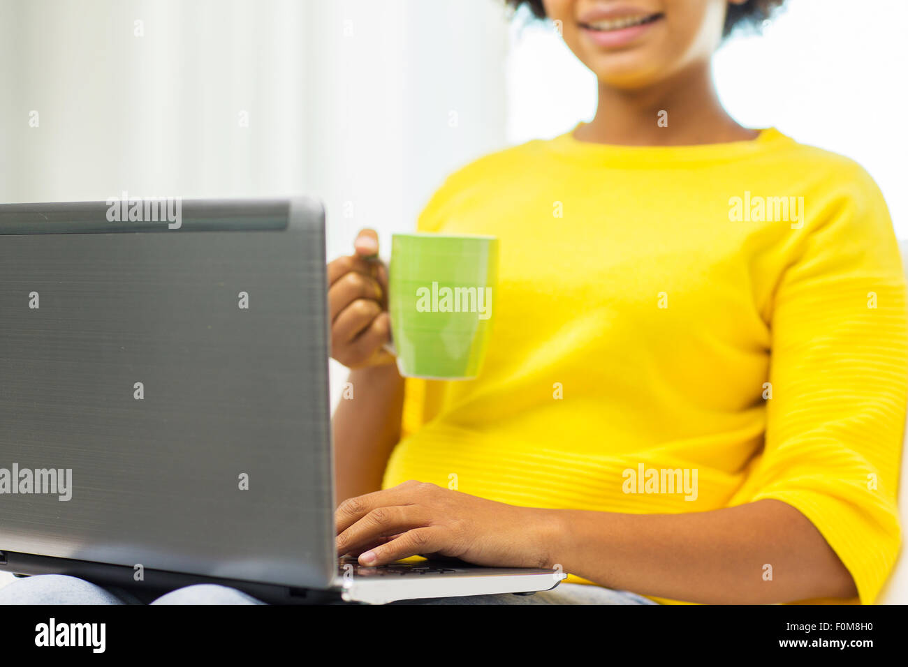 happy african american woman with laptop at home Stock Photo - Alamy