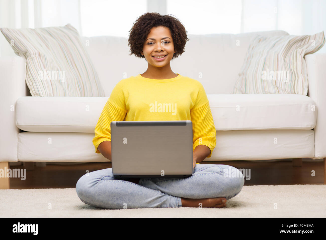happy african american woman with laptop at home Stock Photo - Alamy