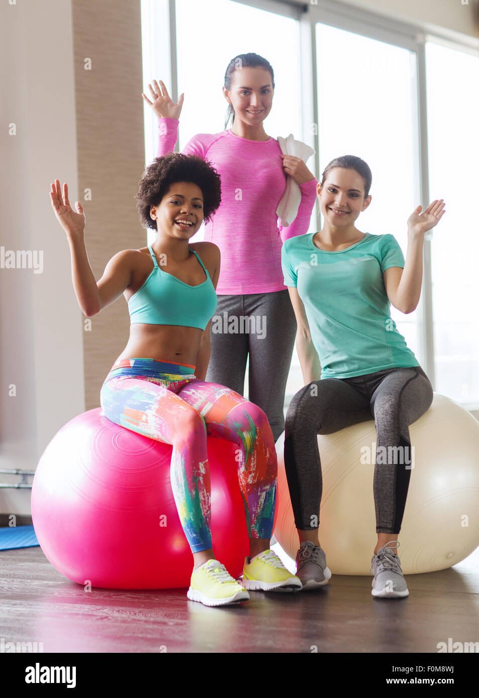 group of smiling women with exercise balls in gym Stock Photo Alamy