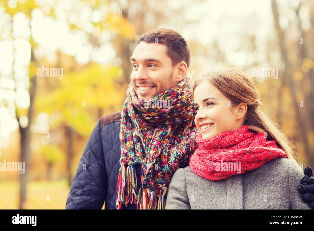 smiling couple hugging on bridge in autumn park Stock Photo - Alamy