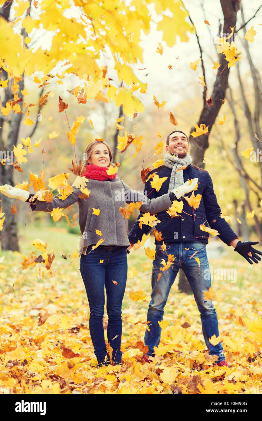 smiling couple having fun in autumn park Stock Photo - Alamy