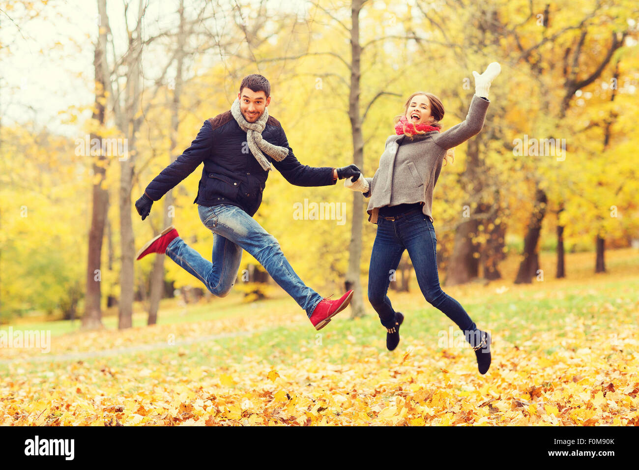 smiling couple having fun in autumn park Stock Photo - Alamy