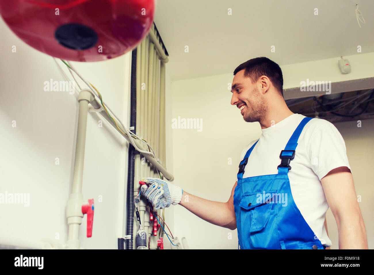 builder or plumber working indoors Stock Photo
