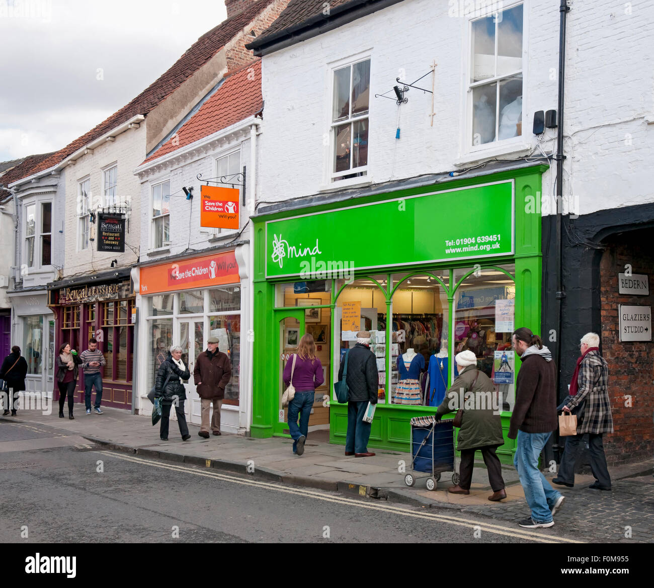 Save the Children and Mind Charity shop store stores shops Goodramgate York North Yorkshire England UK United Kingdom GB Great Britain Stock Photo