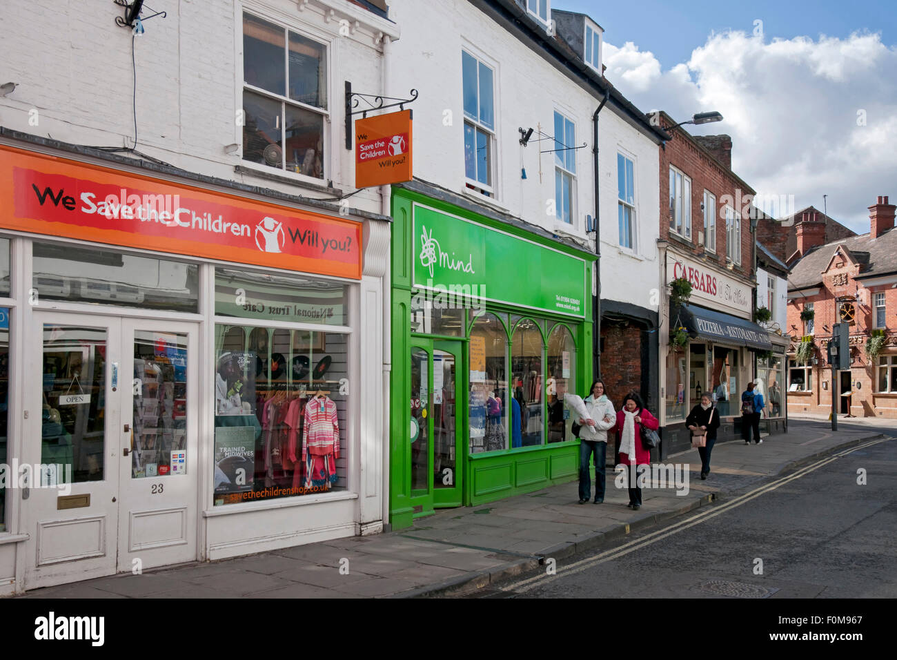 Save the Children and Mind Charity shop store shops stores Goodramgate York North Yorkshire England UK United Kingdom GB Great Britain Stock Photo