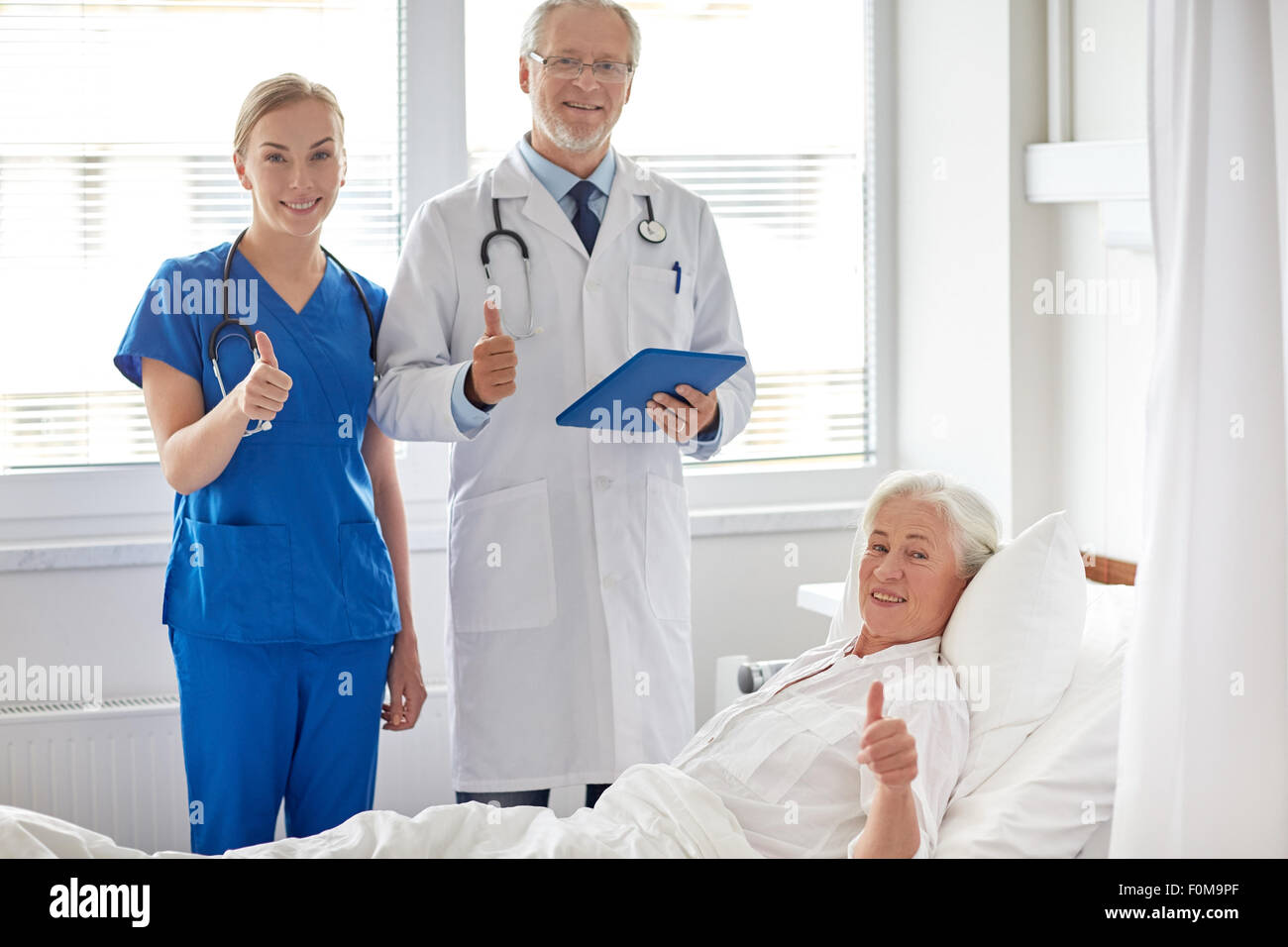 doctor and nurse visiting senior woman at hospital Stock Photo - Alamy