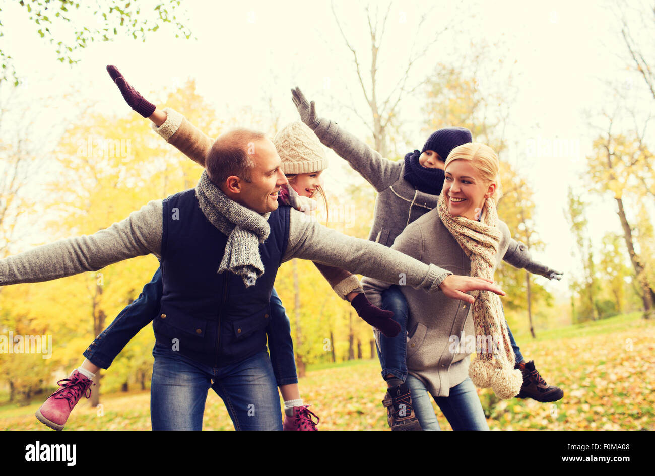 happy family having fun in autumn park Stock Photo - Alamy