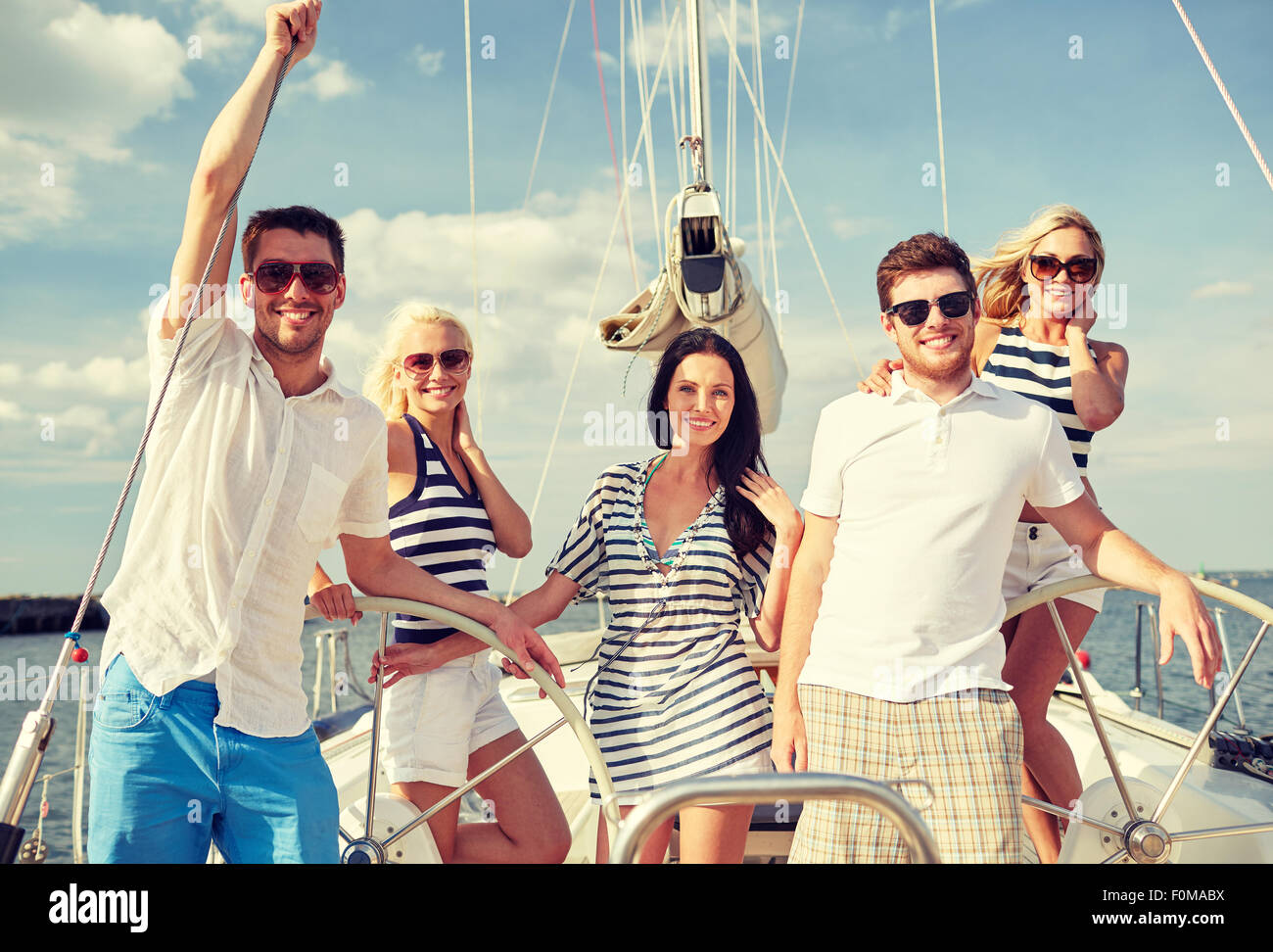 smiling friends sailing on yacht Stock Photo - Alamy