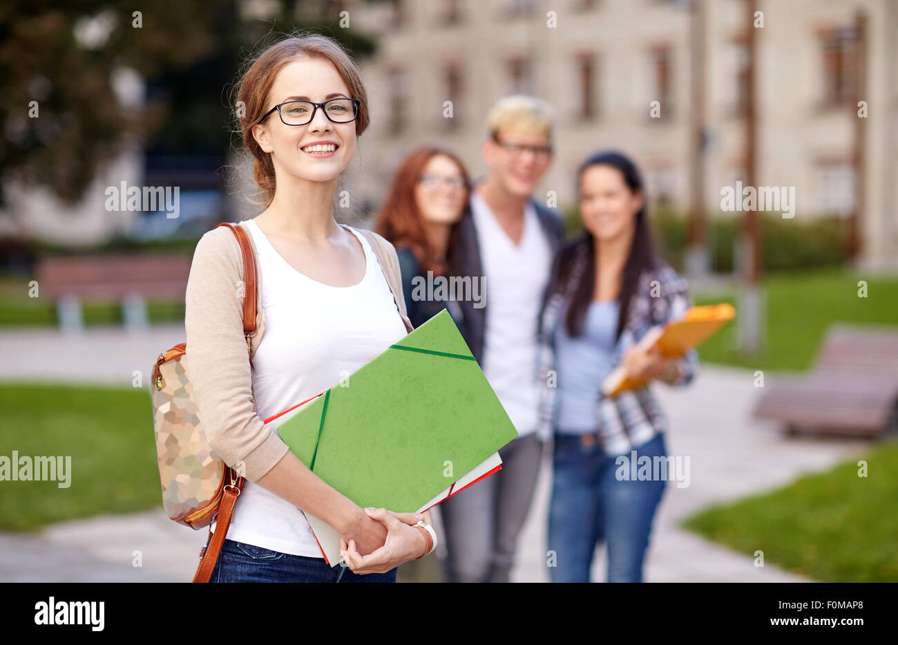 happy teenage students with school folders Stock Photo - Alamy