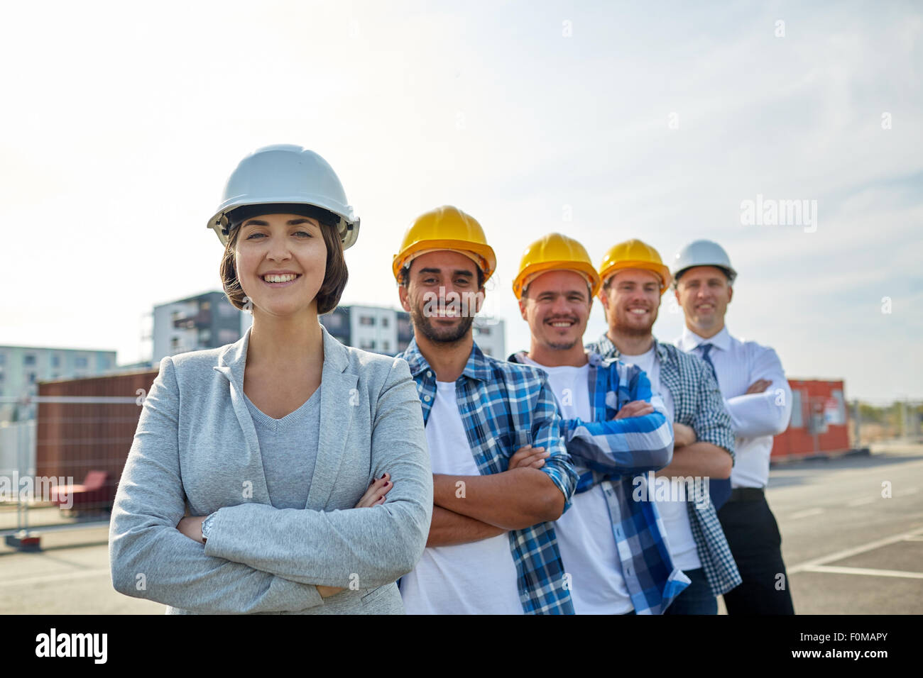 happy builders and architect at construction site Stock Photo