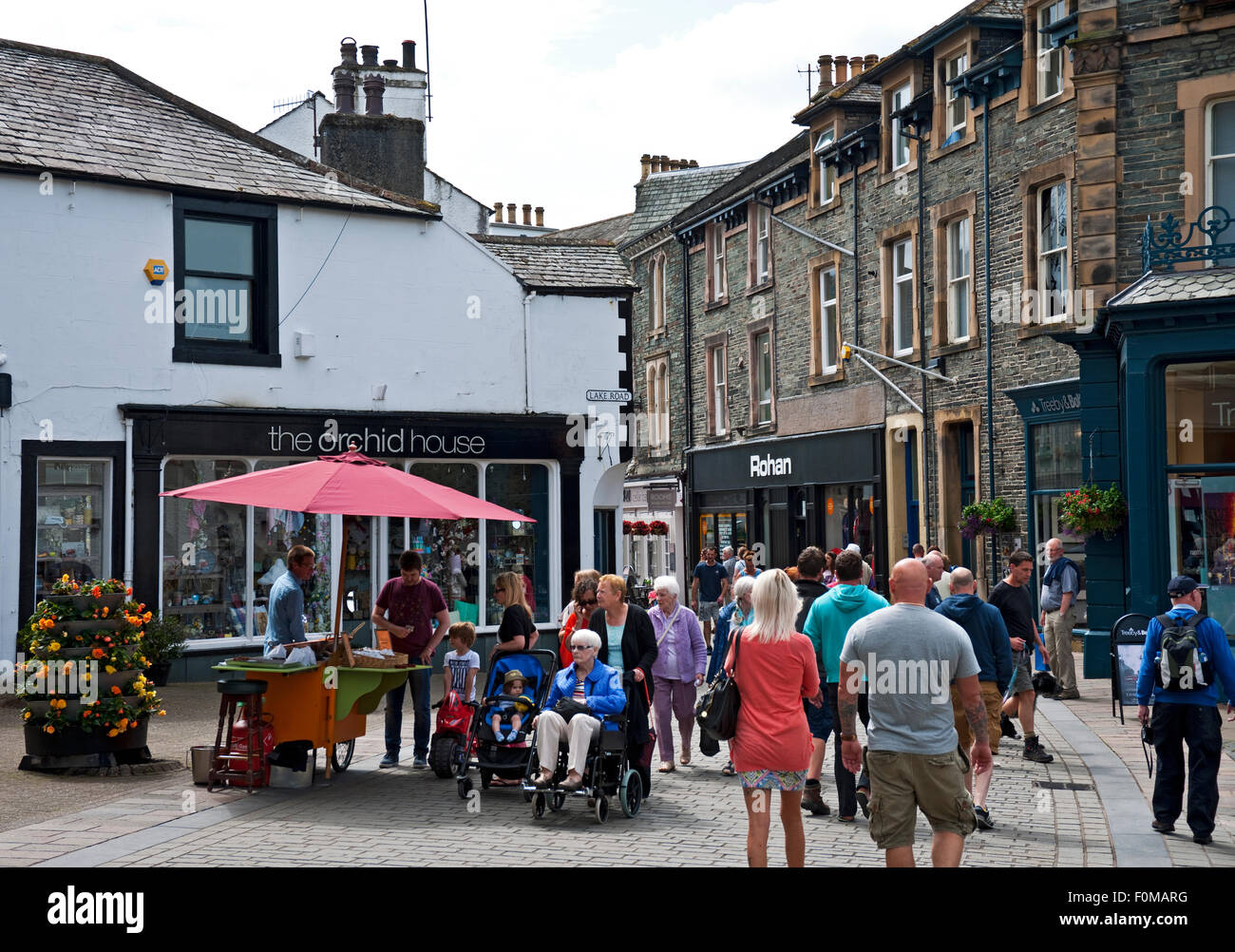 People walking around town centre shops stores the narrow streets of