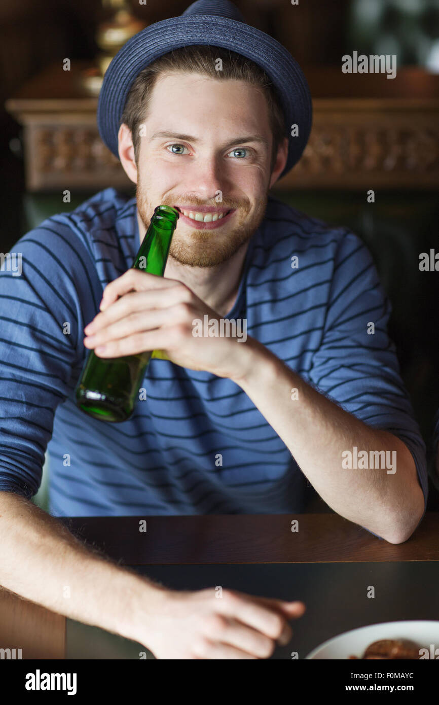 happy young man drinking beer at bar or pub Stock Photo Alamy