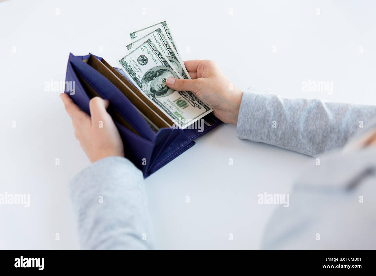 close up of woman hands with wallet and money Stock Photo