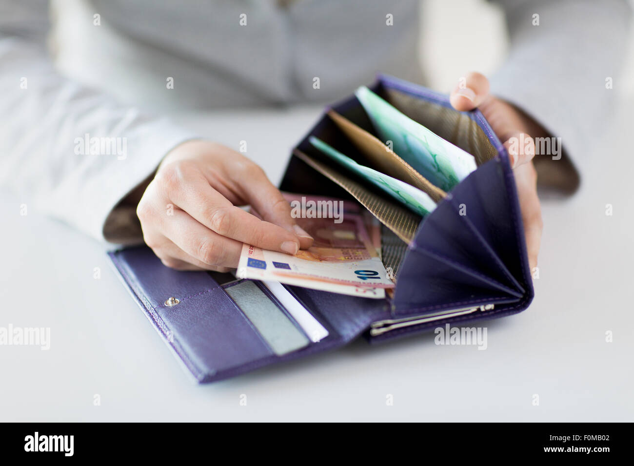 close up of woman hands with wallet and euro money Stock Photo