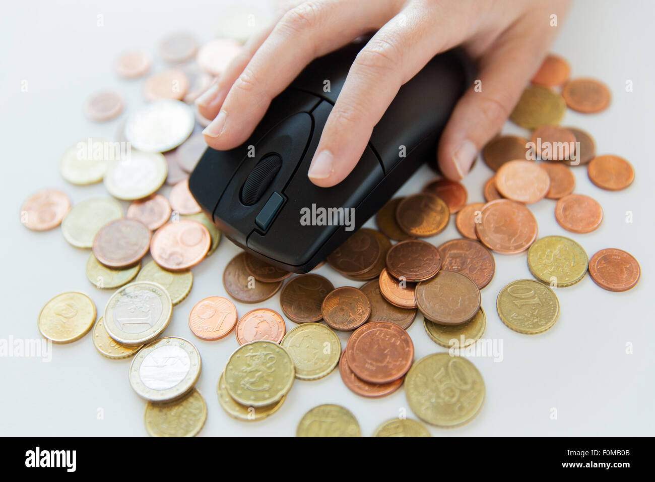 close up of hand with computer mouse on money Stock Photo